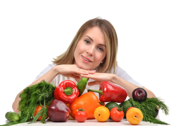 woman working at desk with fresh fruits and vegetables happy smi