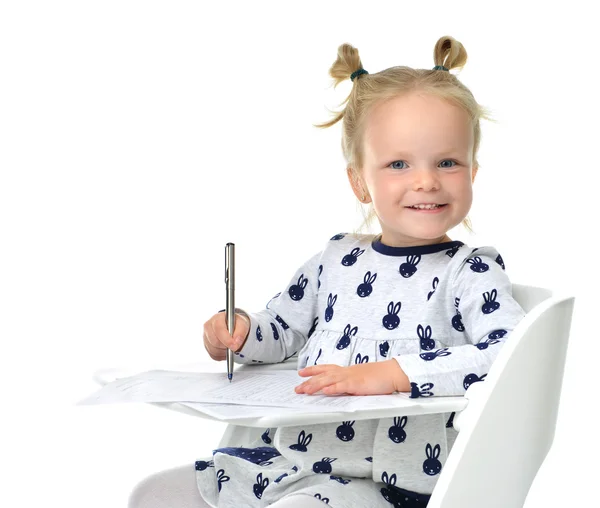 Toddler baby girl learning how to write on a paper book with pen — Stock Photo, Image