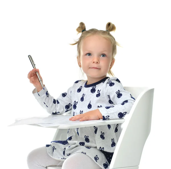 Toddler baby girl learning how to write on a paper book with pen — Stock Photo, Image