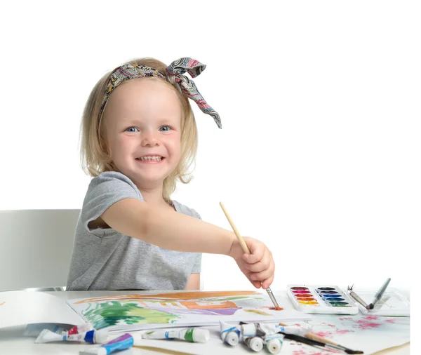 Happy cheerful baby girl child drawing with brush in album with — Stock Photo, Image