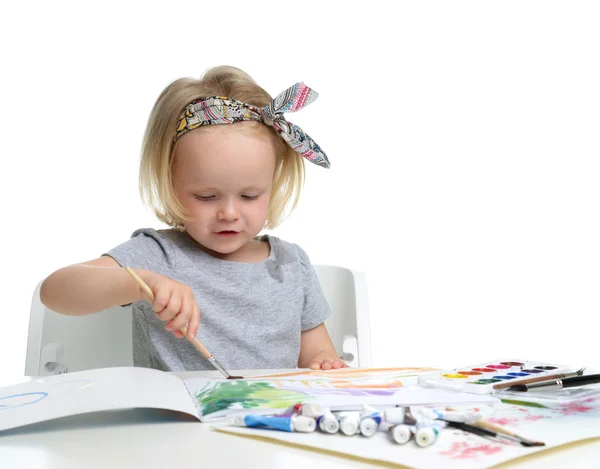 Happy cheerful baby girl child drawing with brush in album with — Stock Photo, Image
