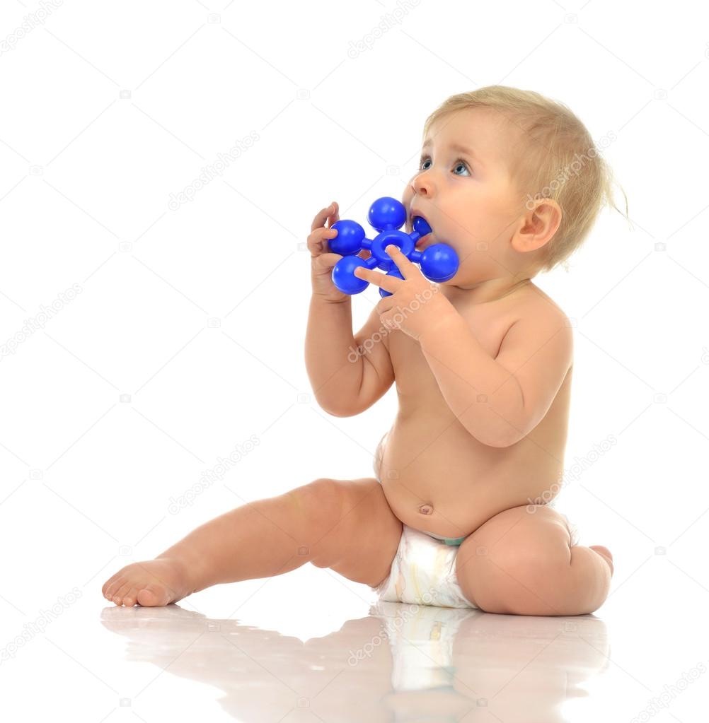 Infant child baby boy toddler playing holding eating blue toy in