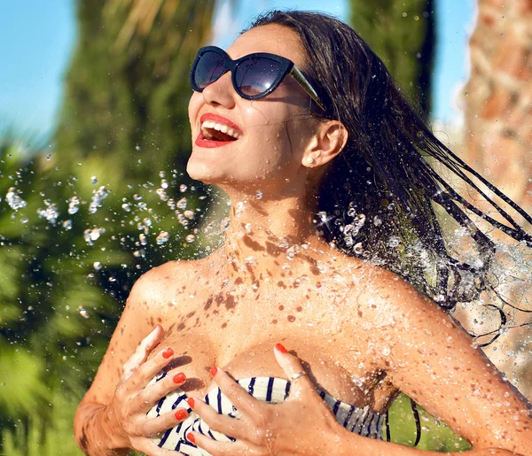 Young beautiful woman with water splashes in sunglasses and biki — Stock Photo, Image