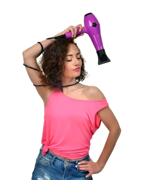 Happy young curly brunette woman with purple hair dryer isolated — Stock Photo, Image