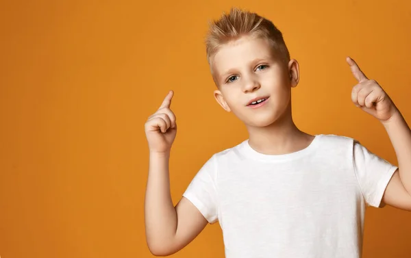 Adolescente colegial inteligente en camiseta blanca en blanco sostiene los dedos hacia arriba, haciendo un gesto Buena idea, Respuesta —  Fotos de Stock