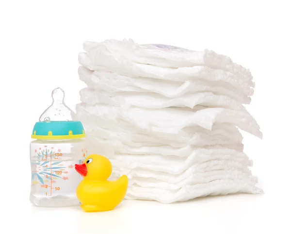 Child stack of diapers baby feeding milk bottle with water — Stock Photo, Image