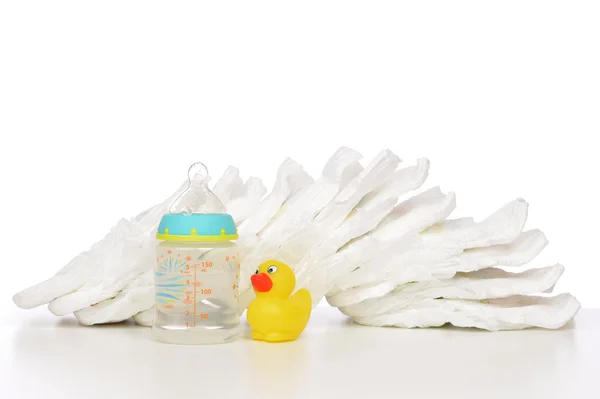 New born child stack of diapers nipple soother baby feeding — Stock Photo, Image