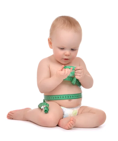 Infant child baby toddler sitting playing with tape measure meas — Stock Photo, Image