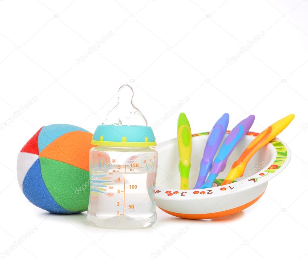 New born infant child composition baby spoons in plate 