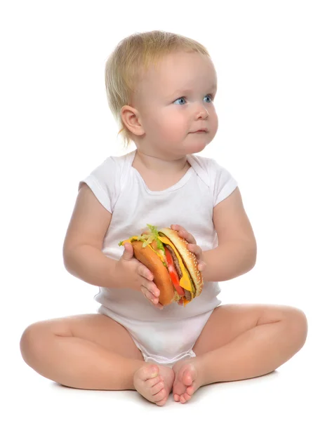 Fast food concept. Infant child baby toddler hold tasty unhealth — Stock Photo, Image