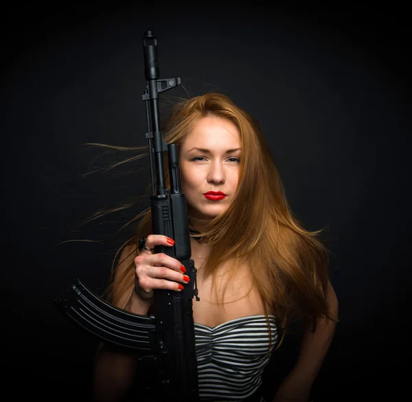 sexy fashion glamour woman holding up her weapon assault rifle g