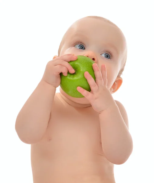 Infant child baby kid  eating green apple blue eyes looking at t — Stock Photo, Image