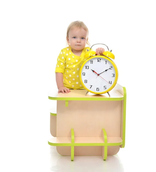 Happy child girl kid standing near little table with big yellow — Stock Photo, Image