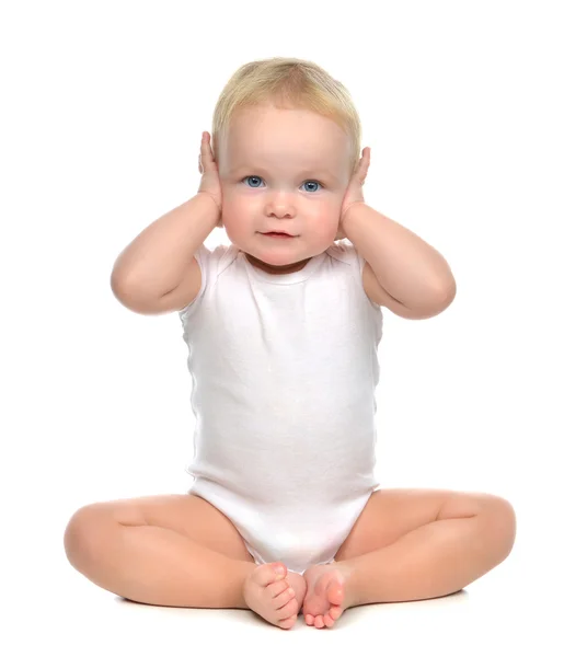 Infant child baby toddler sitting closed her hands over ears and — Stock Photo, Image