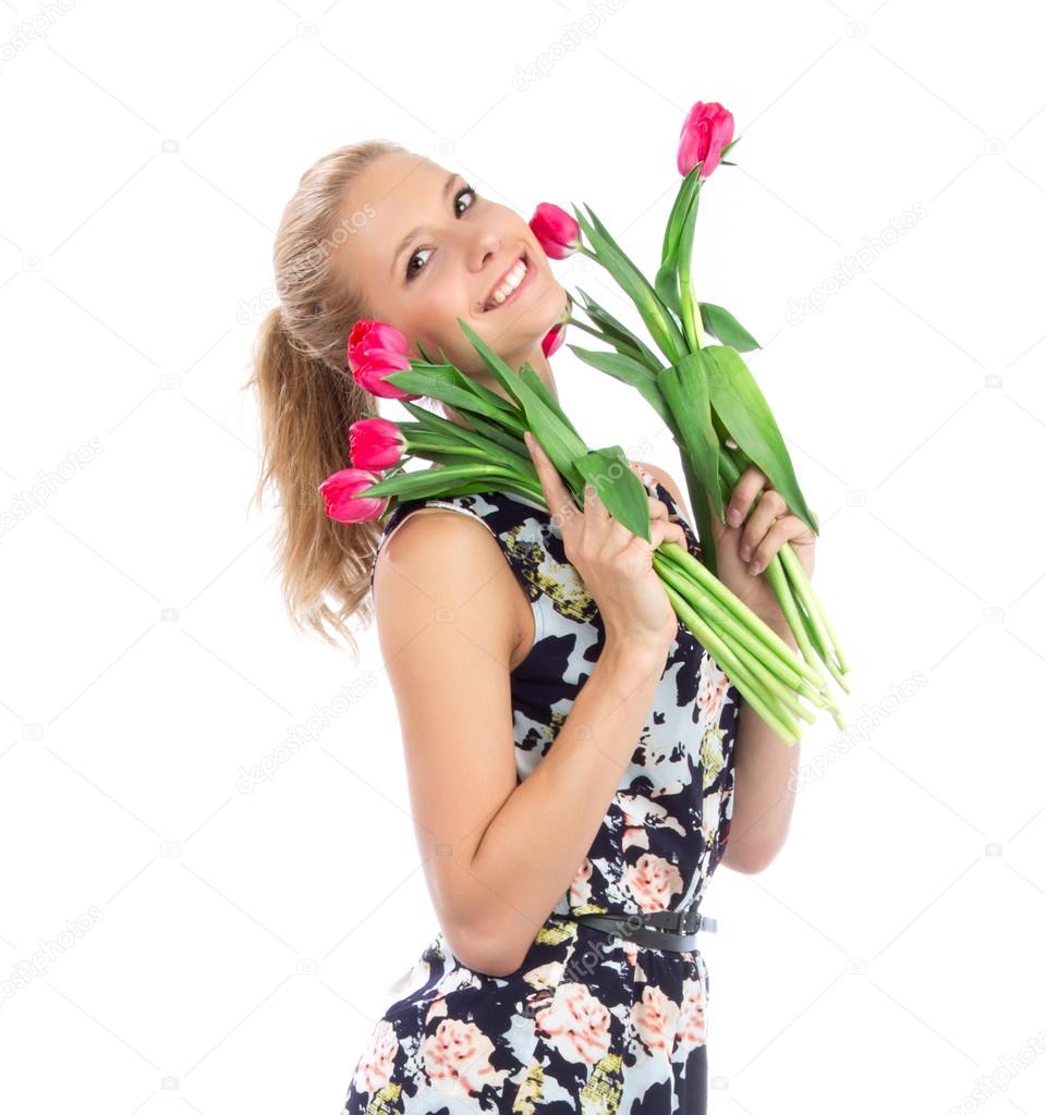 Beautiful happy woman with red tulips bouquet of flowers