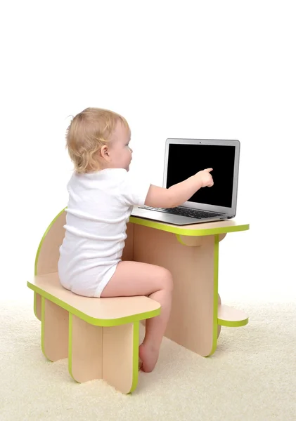 Child baby girl toddler sitting computer laptop pointing finget — Stock Photo, Image