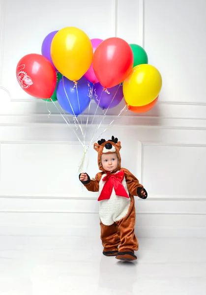 Child baby boy toddler with bunch of colorful balloons in hand f — Stock Photo, Image