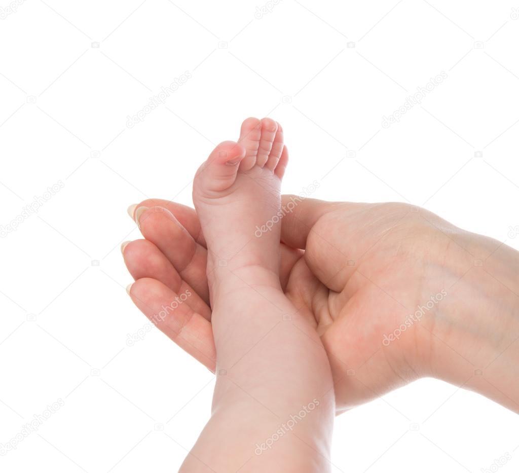 One month new born child baby foot leg in mother hand 