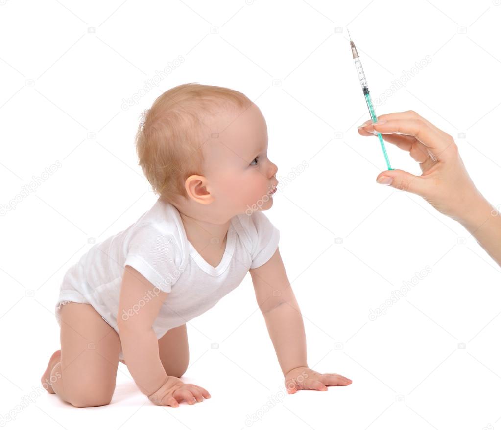 Infant child baby kid hand with medical insulin syringe ready fo