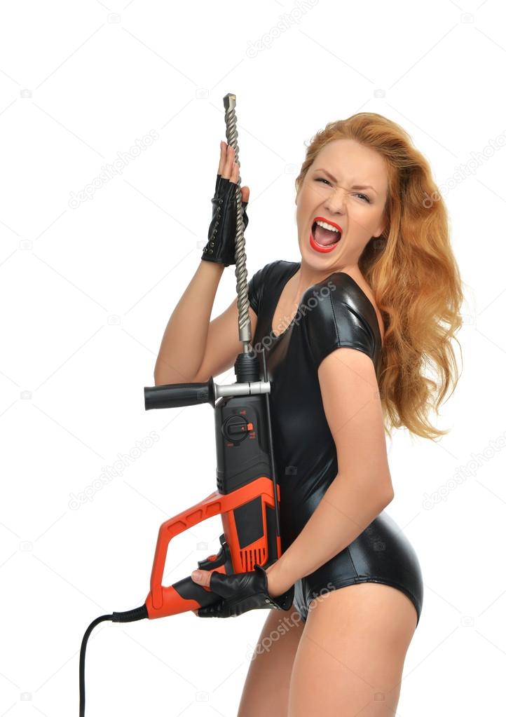Happy young sexy woman contractor worker with construction drill perforato