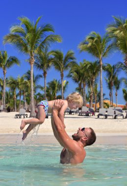 Dad holding baby girl kid in hands tropical sea beach vacation