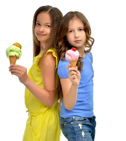 Girls ready eating red green blue raspberry vanilla ice cream in — Stockfoto