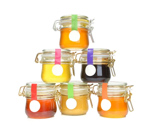 Tasty jars of jam and honey isolated — Stock Photo, Image