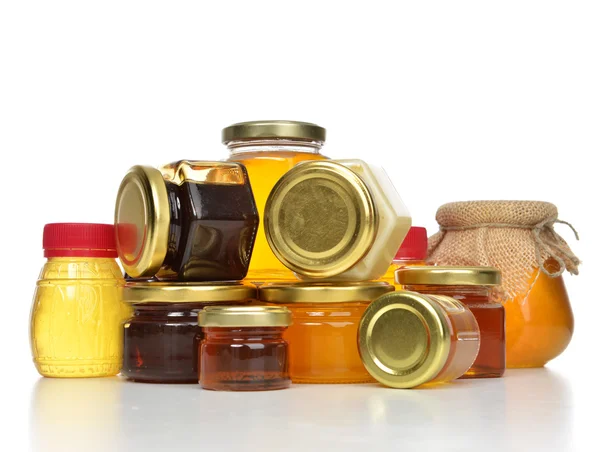 Sweet Tasty jars of jam and honey cream in row composition with — Stock Photo, Image