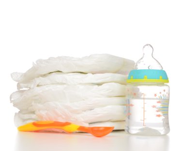 New born baby child stack of diapers spoon baby feeding milk bot