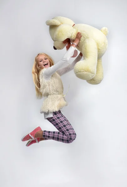 Young pretty teenage girl happy jumping with big teddy bear smil — Stock Photo, Image