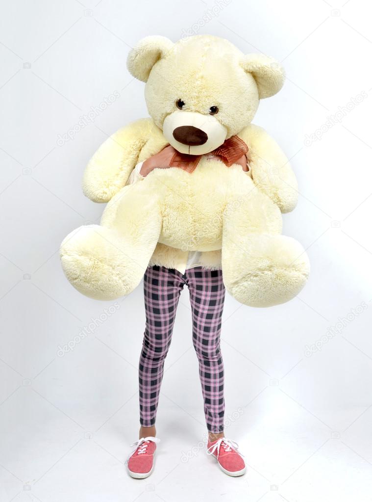 Young pretty teenage girl happy hugging big teddy bear instead o