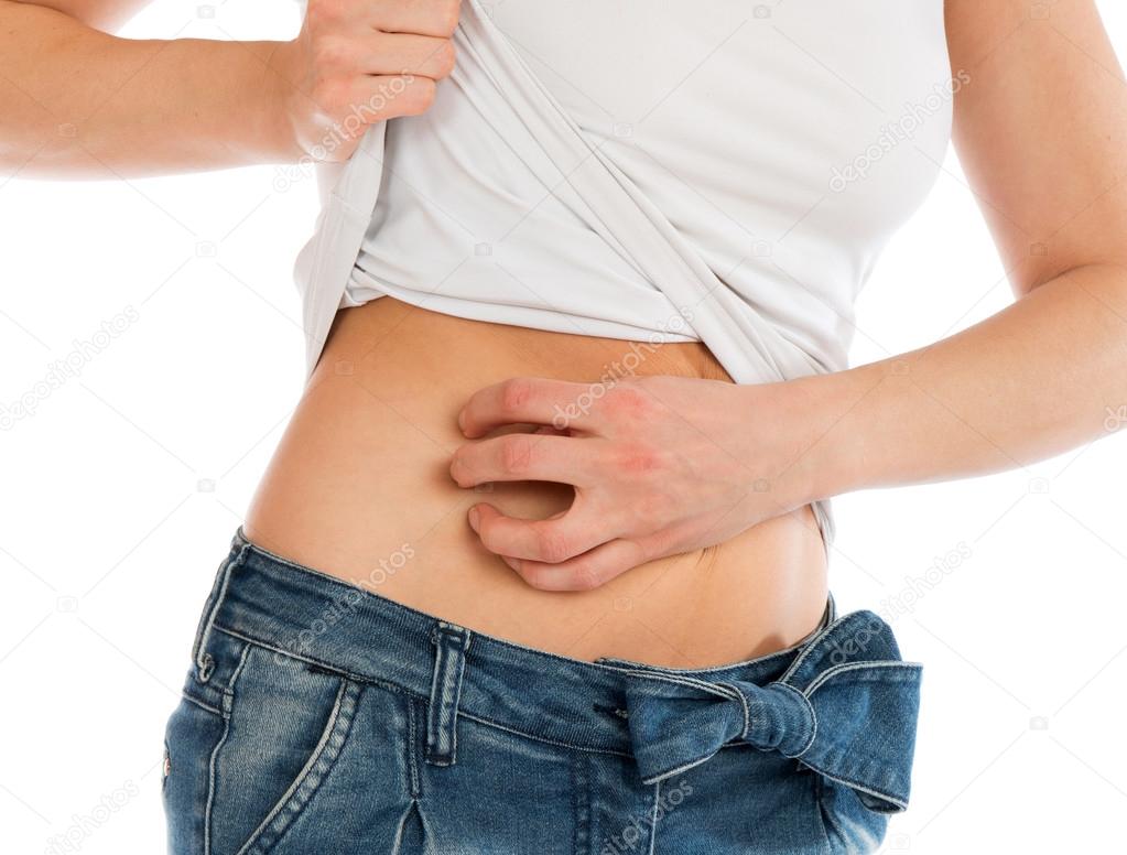 Young woman allergy scratching her abdomen stomach with fingers
