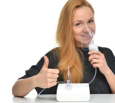 Young woman using nebulizer mask for respiratory inhaler Asthma clipart