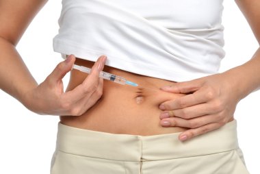 Diabetes patient make insulin shot by syringe with dose of humal