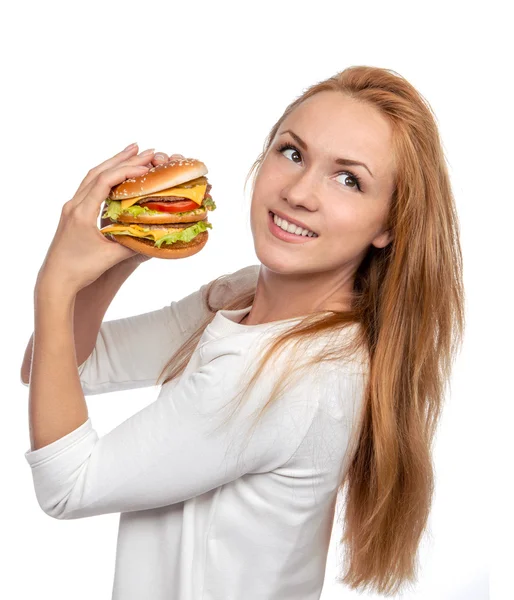 Conceito de fast food. Saboroso sanduíche de hambúrguer insalubre em mãos penduradas — Fotografia de Stock