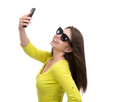 Young pretty girl in sunglasses make self portrait selfie with h