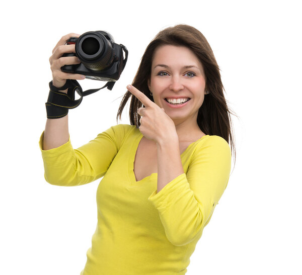 Young female photographer taking photos looking at new digital c