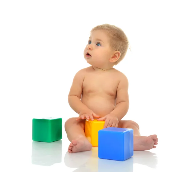 Infant child baby boy toddler playing holding green blue yellow — Stock Photo, Image