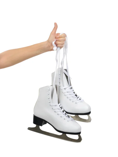 Hand with thumb up sign holding woman ice skates isolated — Stock Photo, Image