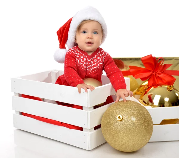 Christmas baby child in santa hat hold gold ball decoration near — 스톡 사진