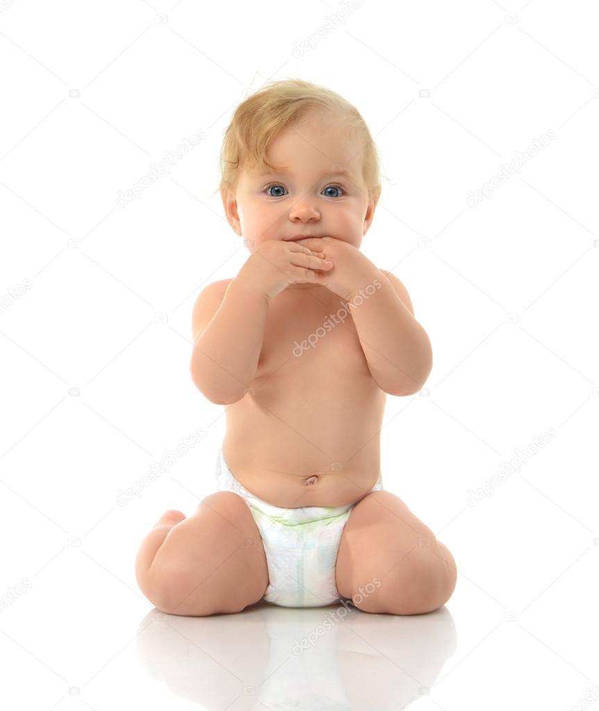 Infant child baby girl in diaper sitting happy looking at the ca