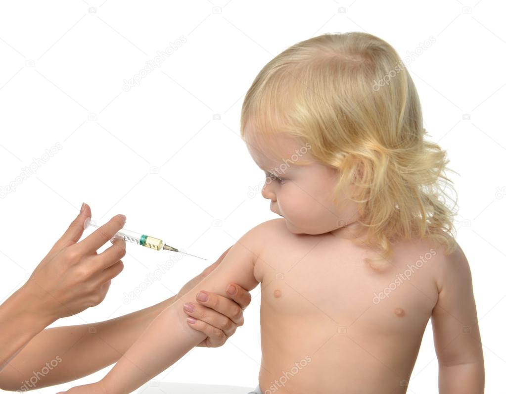 Doctor hand with syringe vaccinating child baby kid flu injectio