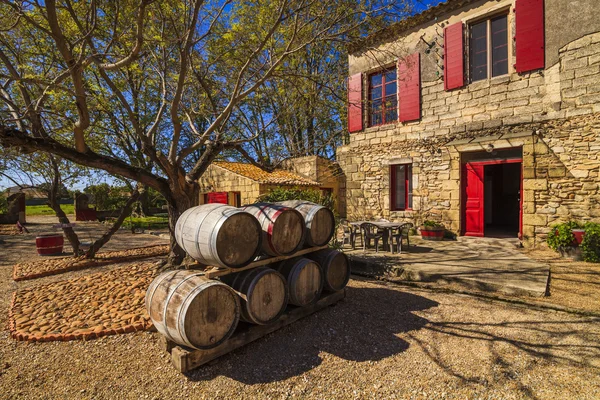 Wine barrels in the background of an ancient house. France. Lang