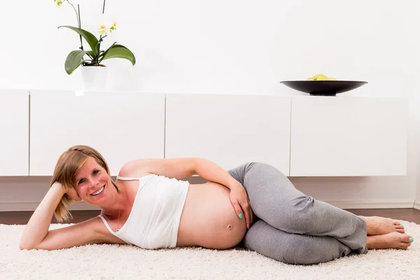Mujer rubia embarazada en su casa . — Foto de Stock