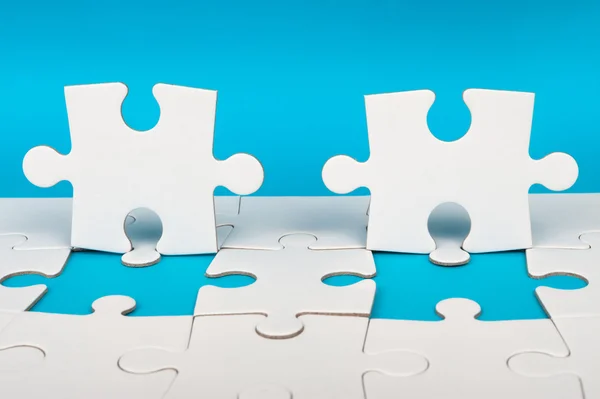 Group of white paper jigsaw puzzles — Stock Photo, Image