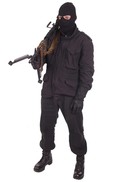 Žoldák v černých uniformách s kulometem — Stock fotografie