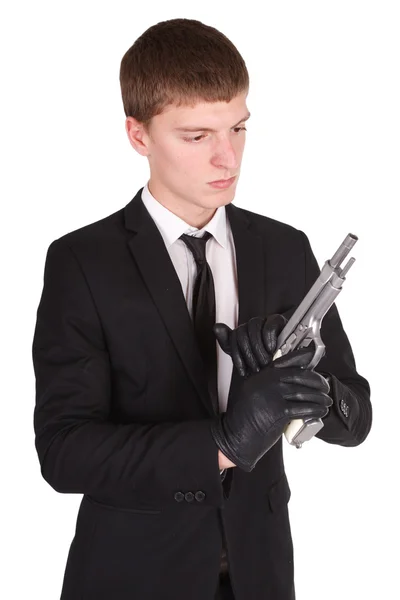 Man in black costume and handgun — Stock Photo, Image