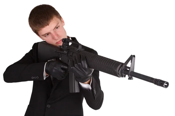 Man in black costume and rifle — Stock Photo, Image