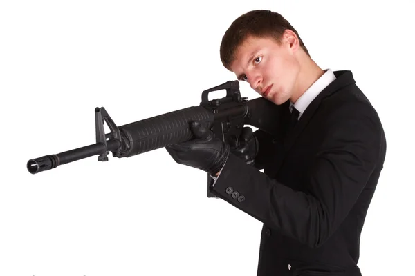 Man in black costume and rifle — Stock Photo, Image