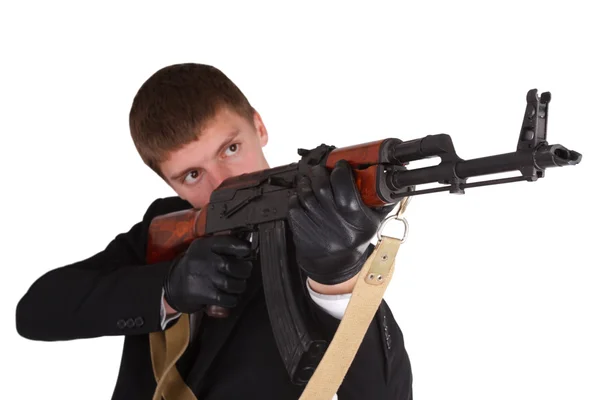 Man in black suit and ak 47 — Stock Photo, Image